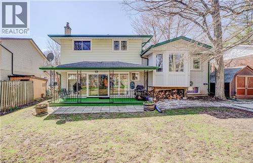 Rear view of house with a chimney, brick siding, and a storage unit - 564 Glen Manor Boulevard, Waterloo, ON - Outdoor With Deck Patio Veranda
