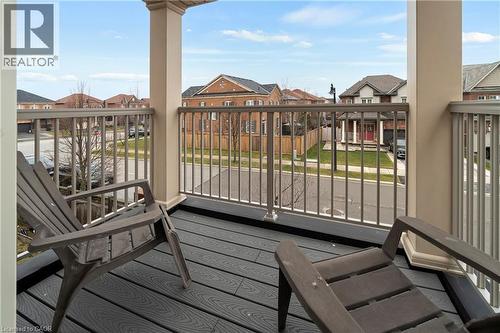 The property features a balcony with composite decking, providing an elevated view of the neighborhood - 4 Macbean Crescent, Waterdown, ON - Outdoor With Balcony With Exterior