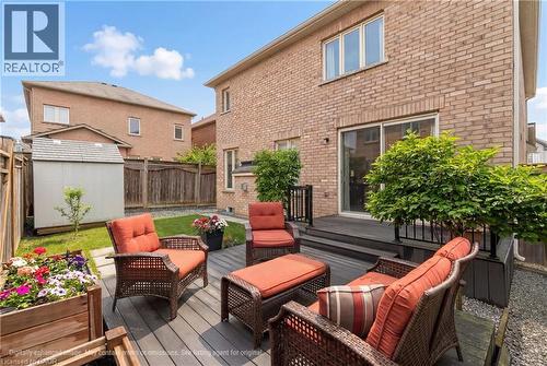 The property features a brick exterior with a rear deck and sliding glass doors - 4 Macbean Crescent, Waterdown, ON - Outdoor With Deck Patio Veranda With Exterior