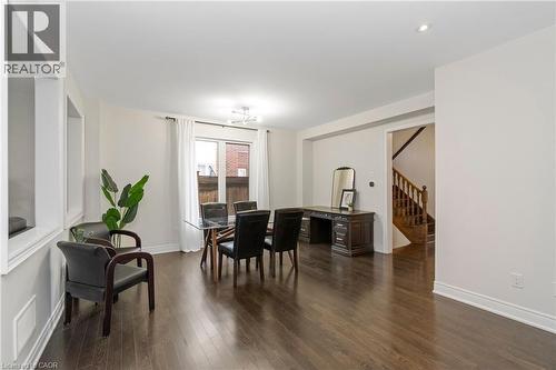 Open concept space featuring dark hardwood flooring throughout, recessed lighting, and white walls - 4 Macbean Crescent, Waterdown, ON - Indoor