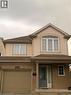 The property features a brick and siding exterior, an integrated garage, and a covered porch entrance - 679 Commonwealth Crescent Unit# Lower, Kitchener, ON  - Outdoor With Exterior 