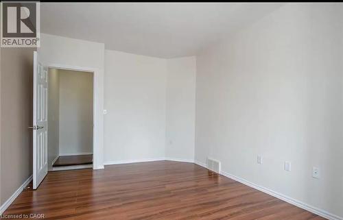 Living space featuring rich wood flooring, white baseboards, and neutral wall paint - 679 Commonwealth Crescent Unit# Lower, Kitchener, ON - Indoor Photo Showing Other Room