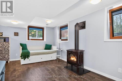 23 Crown Court, Tiny, ON - Indoor Photo Showing Bedroom With Fireplace