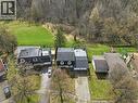 Aerial view of the property and its surroundings, showcasing a large grassy area behind the house and a wooded backdrop - 37 Parkview Crescent, Kitchener, ON  - Outdoor With View 