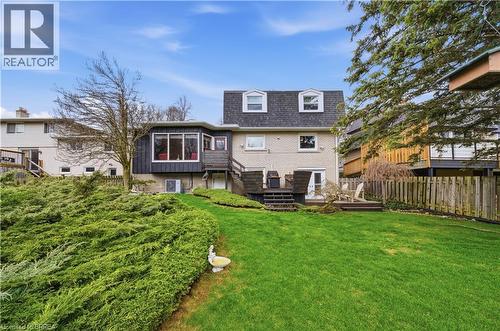 The property features an extensive backyard with a well-maintained lawn and mature shrubs - 37 Parkview Crescent, Kitchener, ON - Outdoor