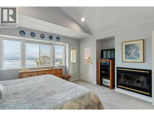 3471 Mcbride Road, Blind Bay, BC - Indoor Photo Showing Bedroom With Fireplace
