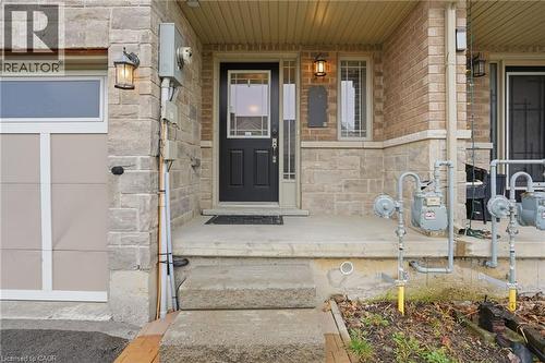 View of exterior entry featuring stone siding and covered porch - 91 Chamomile Drive, Hamilton, ON - Outdoor