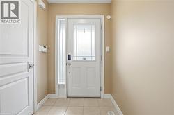 Entryway featuring tile patterned flooring and baseboards - 