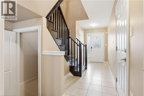 Entrance foyer featuring stairs and light tile patterned floors - 91 Chamomile Drive, Hamilton, ON - Indoor Photo Showing Other Room
