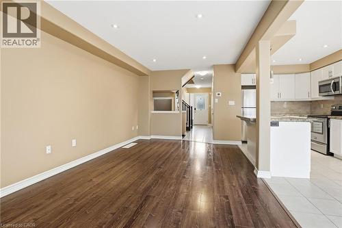 Unfurnished living room with light wood-style flooring and recessed lighting - 91 Chamomile Drive, Hamilton, ON - Indoor Photo Showing Kitchen
