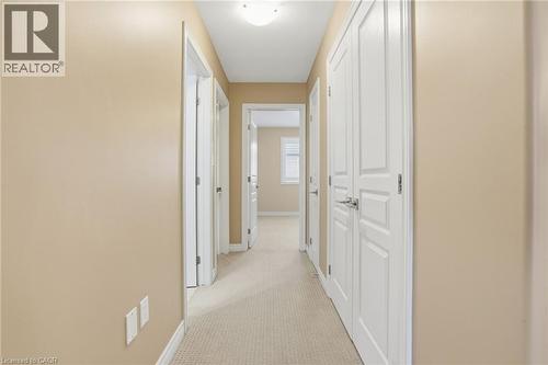 Hallway featuring light carpet and baseboards - 91 Chamomile Drive, Hamilton, ON - Indoor Photo Showing Other Room