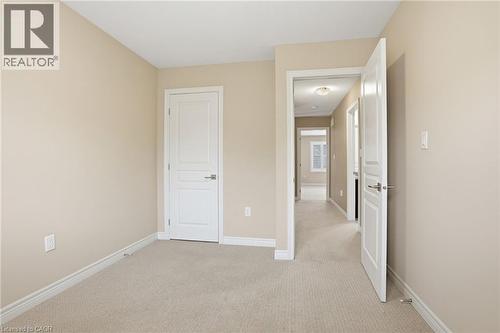 Unfurnished bedroom with light carpet and baseboards - 91 Chamomile Drive, Hamilton, ON - Indoor Photo Showing Other Room