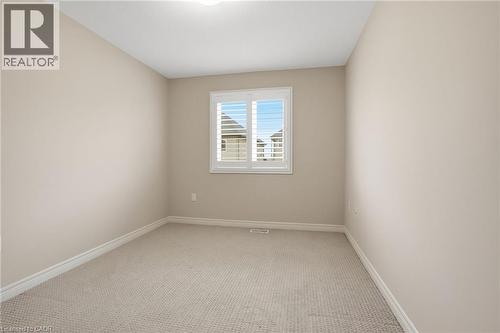 Unfurnished room featuring light colored carpet and baseboards - 91 Chamomile Drive, Hamilton, ON - Indoor Photo Showing Other Room