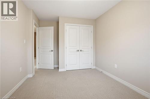 Unfurnished bedroom with light carpet and a closet - 91 Chamomile Drive, Hamilton, ON - Indoor Photo Showing Other Room