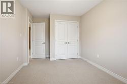 Unfurnished bedroom with light carpet and a closet - 