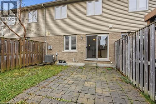 Rear view of house with a fenced backyard, a patio area, entry steps, and brick siding - 91 Chamomile Drive, Hamilton, ON - Outdoor With Exterior