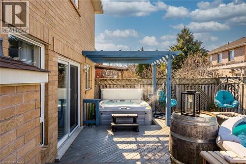 Wooden deck featuring a hot tub and a fenced backyard - 599 Caverhill Crescent, Milton, ON - Outdoor With Deck Patio Veranda