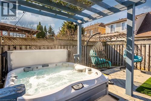 Fenced backyard with a wooden deck, a pergola, and a hot tub - 599 Caverhill Crescent, Milton, ON - Outdoor With Deck Patio Veranda