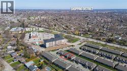 Aerial view of the property, highlighted in red, situated within a community featuring residential buildings and nearby amenities - 