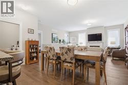 This open concept living space features hardwood floors and neutral wall tones - 