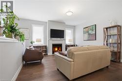 This living area features hardwood floors and light gray walls - 