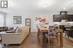 This inviting space features light-colored walls and dark wood flooring throughout - 