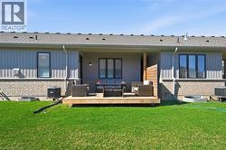 The property features a well-maintained lawn and a private wooden deck, perfect for outdoor enjoyment - 