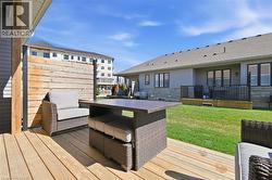The property features a spacious wooden deck with a privacy screen, providing an ideal outdoor living space - 