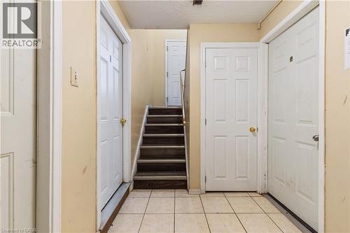 Stairway with a textured ceiling and tile patterned flooring - 23 Amherst Drive, Kitchener, ON - Indoor Photo Showing Other Room
