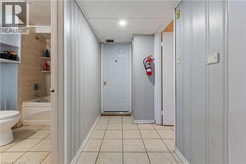 Corridor featuring light tile patterned flooring and baseboards - 23 Amherst Drive, Kitchener, ON - Indoor Photo Showing Bathroom