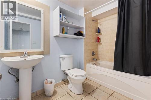 Full bathroom featuring shower / tub combo with curtain and tile patterned flooring - 23 Amherst Drive, Kitchener, ON - Indoor Photo Showing Bathroom