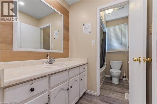 Bathroom with vanity, shower / tub combo, and dark wood-style flooring - 23 Amherst Drive, Kitchener, ON - Indoor Photo Showing Bathroom