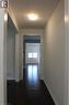 Hallway featuring dark wood-finish flooring, white baseboards, and a flush-mount ceiling light fixture - 40 Compass Trail, Cambridge, ON  - Indoor Photo Showing Other Room 