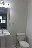 Pedestal sink with chrome faucet, mirror, and two-light vanity fixture - 40 Compass Trail, Cambridge, ON  - Indoor Photo Showing Bathroom 