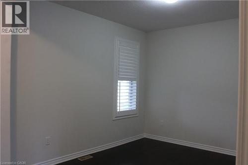 Room featuring dark wood-finish flooring and light-toned walls - 40 Compass Trail, Cambridge, ON - Indoor Photo Showing Other Room