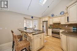 Spacious kitchen with an abundance of cabinets. - 