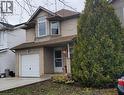The property features a brick and siding exterior, a white garage door, and a front entrance with a covered porch - 725 Paris Boulevard, Waterloo, ON  - Outdoor 