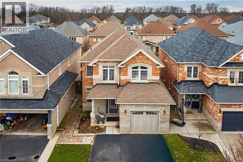 Exterior view of the property featuring a paved driveway, an attached garage, and a covered front entrance - 44 Matteo Trail, Hamilton, ON - Outdoor With Facade