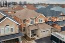 This property features a two-story design with a brick and stone facade, a covered front porch, and an attached garage - 44 Matteo Trail, Hamilton, ON  - Outdoor 