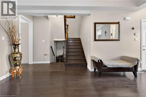 The property features dark wood flooring and a staircase with wooden treads - 44 Matteo Trail, Hamilton, ON - Indoor