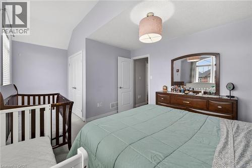 This room features light-colored walls, a window with blinds, and white doors - 44 Matteo Trail, Hamilton, ON - Indoor Photo Showing Bedroom