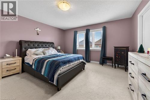 Bedroom with a light-colored carpeted floor and painted walls - 44 Matteo Trail, Hamilton, ON - Indoor Photo Showing Bedroom