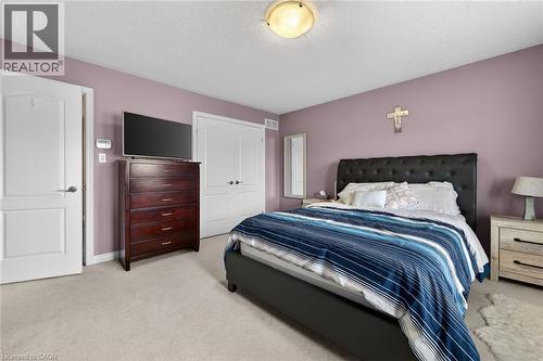 This room features light purple walls, white trim, and light-colored carpet - 44 Matteo Trail, Hamilton, ON - Indoor Photo Showing Bedroom