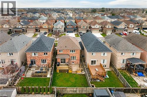 The property features a well-maintained lawn and a wooden deck - 44 Matteo Trail, Hamilton, ON - Outdoor