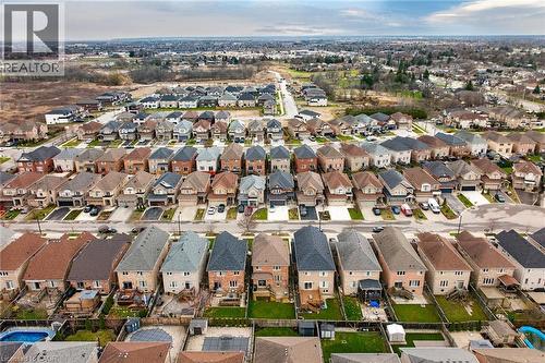 Aerial view of a residential neighbourhood featuring a variety of properties with sloped roofs and private driveways - 44 Matteo Trail, Hamilton, ON - Outdoor With View