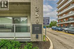 The property features a concrete and brick exterior, with a balcony that includes a glass railing - 