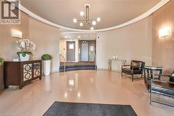 The property features a spacious entrance area with polished tile flooring, curved walls, and recessed lighting - 