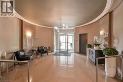 The property features a welcoming common area with a curved ceiling, recessed lighting, and wall sconces, showcasing a polished floor - 