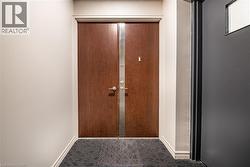 Entryway featuring double doors with modern hardware, leading into the property - 