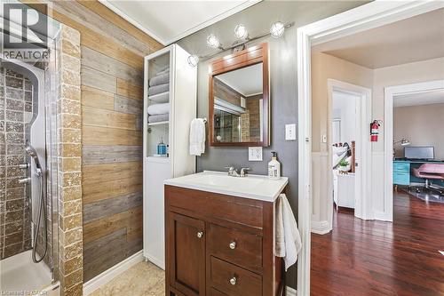 The property's bathroom features a vanity with a white countertop and a dark wood cabinet - 30 Grand Avenue, Caledonia, ON - Indoor Photo Showing Bathroom